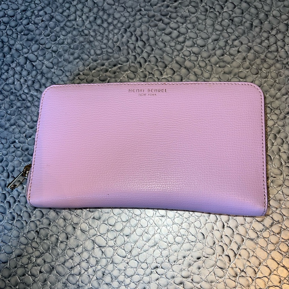 Henri Bendel pink wallet with gold zipper.